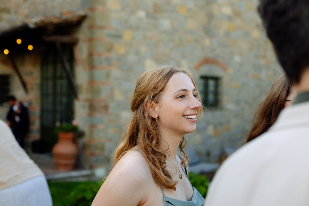 Candid moment during outdoor social gathering at stone villa venue.
