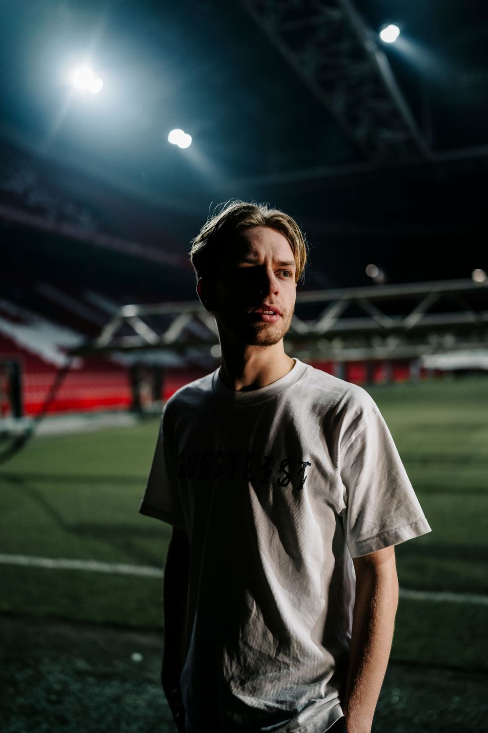 Dramatic nighttime sports field photography sequence with stadium lights creating moody atmosphere.
