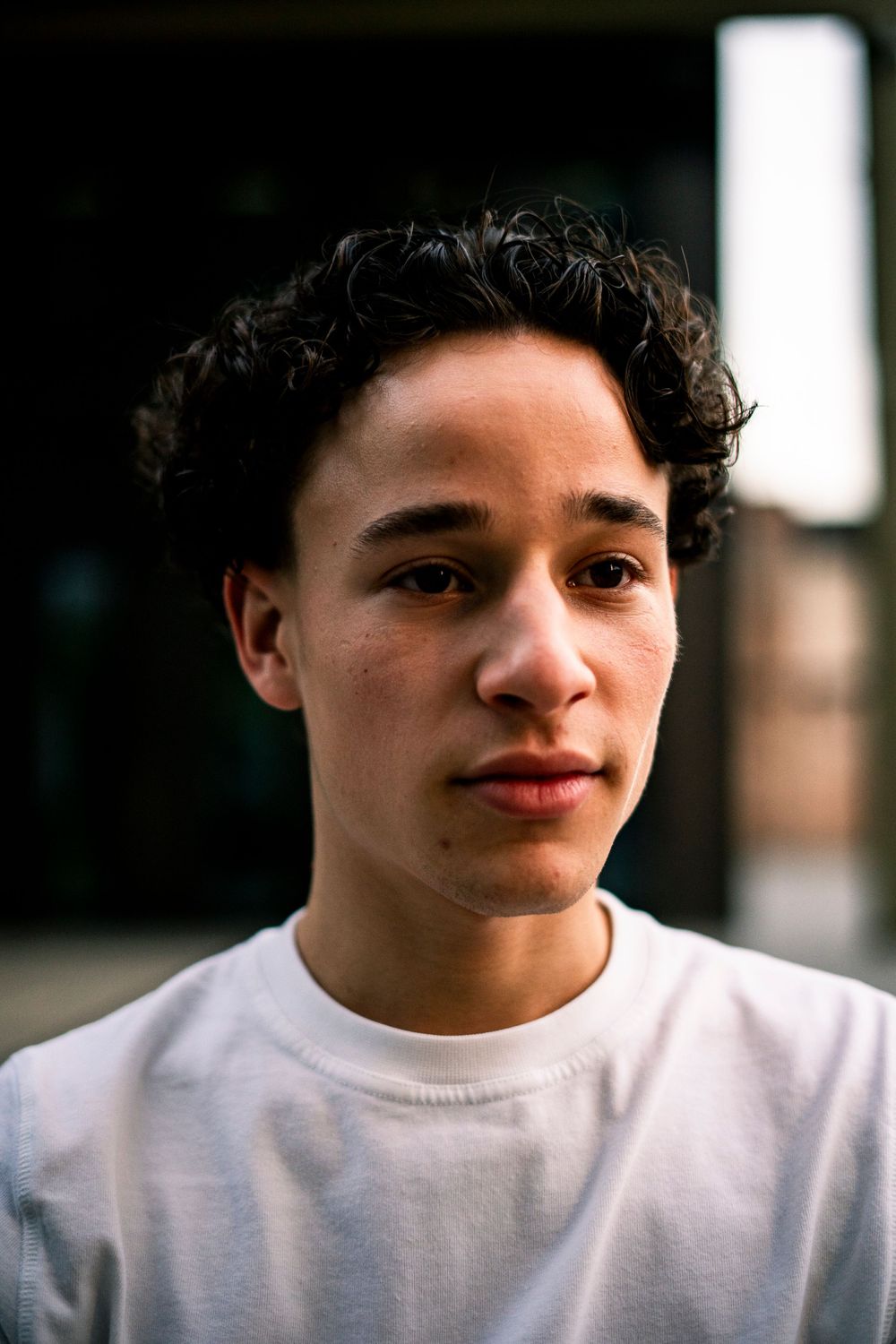Close-up portrait sequence in natural lighting wearing a white shirt.