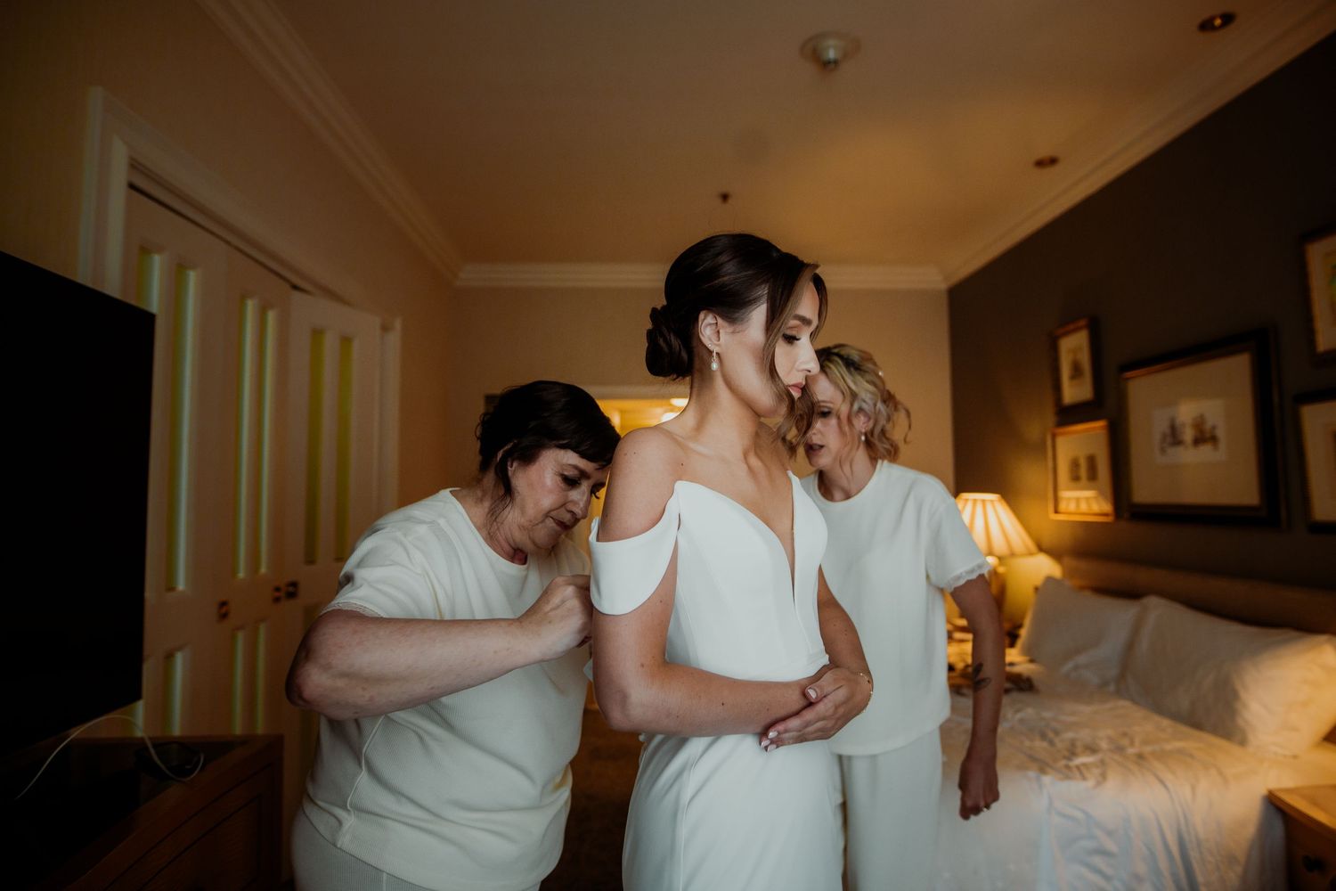 Wedding preparation moment captured in a warmly lit hotel room  London wedding photographer. The landmark