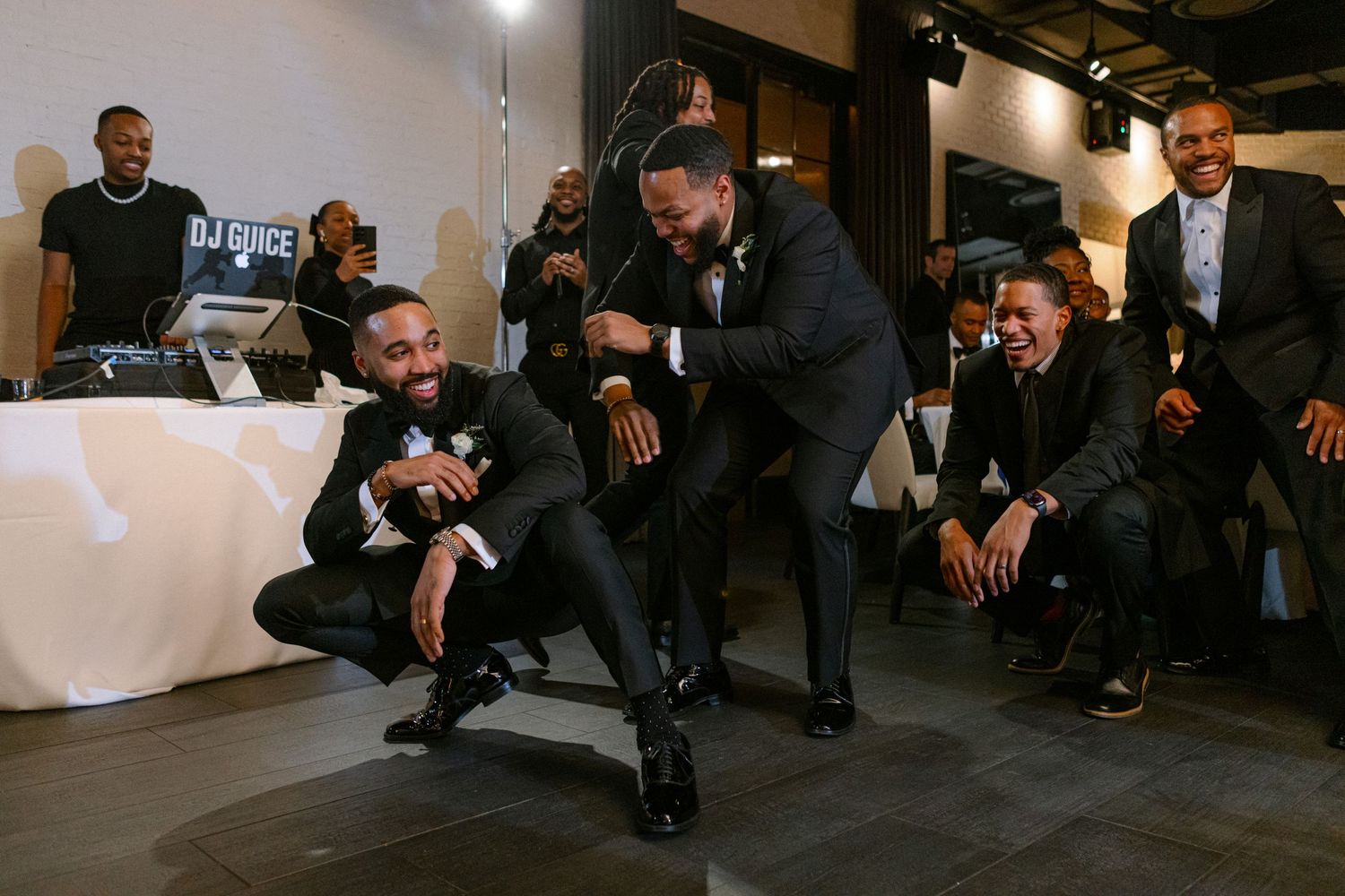 Groomsmen having fun and posing casually during wedding celebration.