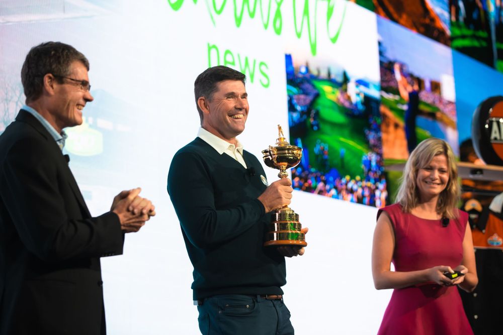 Pádraig Harrington presenting trophy at conference to executives