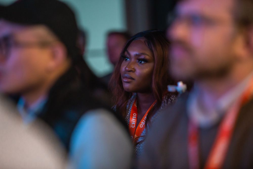 woman in crowd listening during technology conference at Phoenix event space