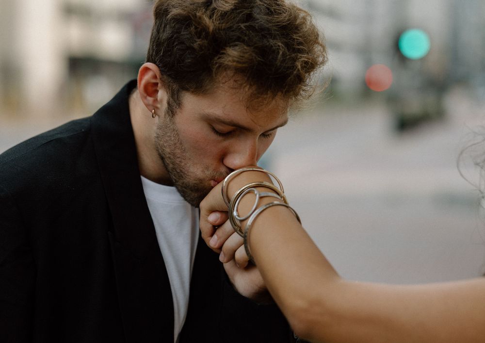 An intimate moment captured between two people during an urban wedding photoshoot.