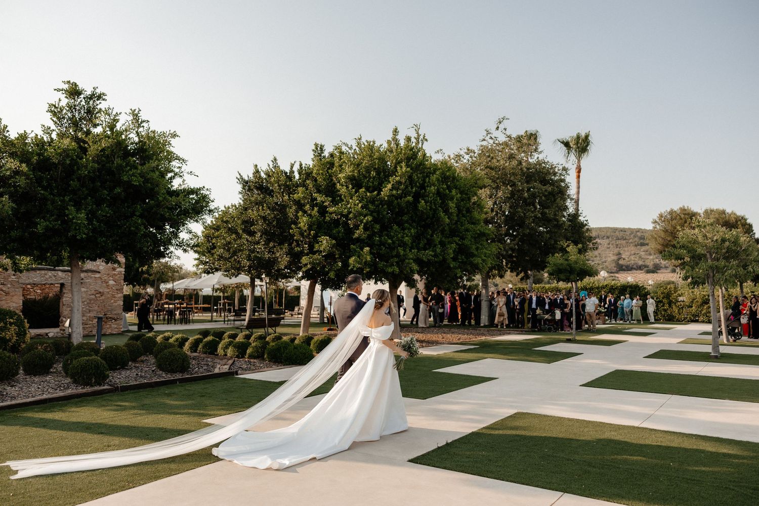 Bride and groom share romantic moment under elegant arched doorway.