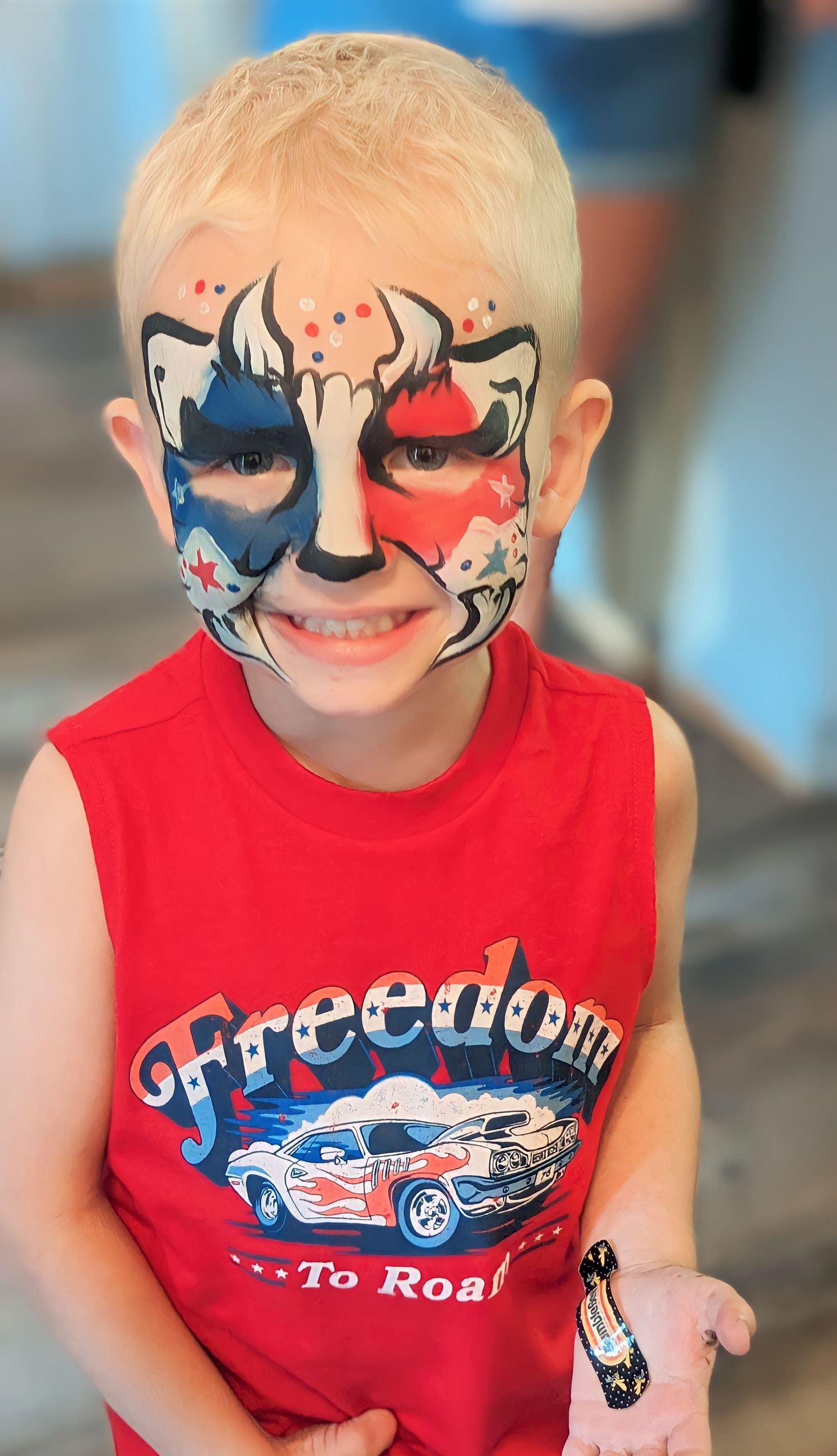 Child patriotic dinosaur face paint in London, OH for 4th of July community and firework event