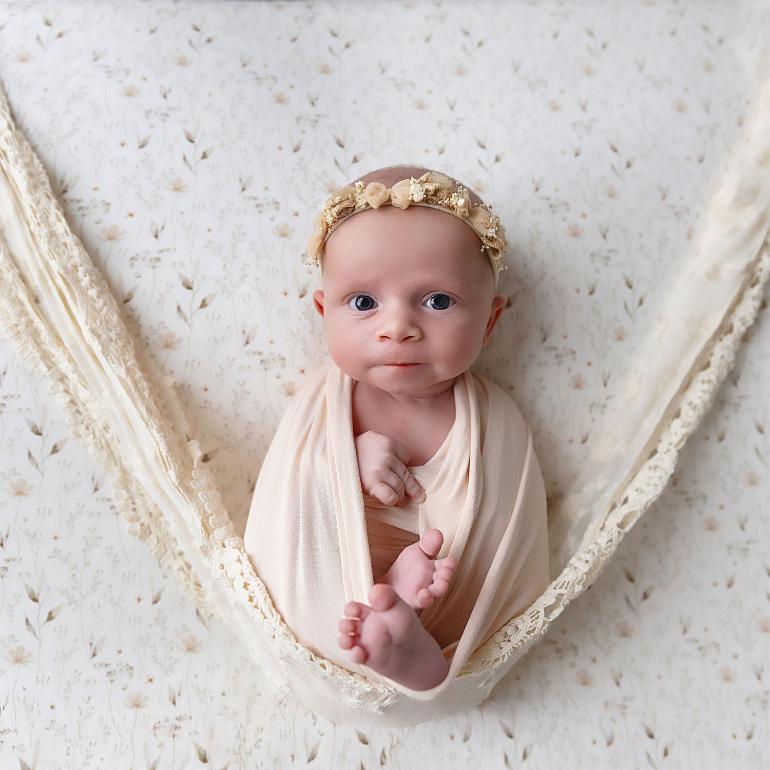 Picture of Baby girl on a meadow flower background with a halo of flowers on her head