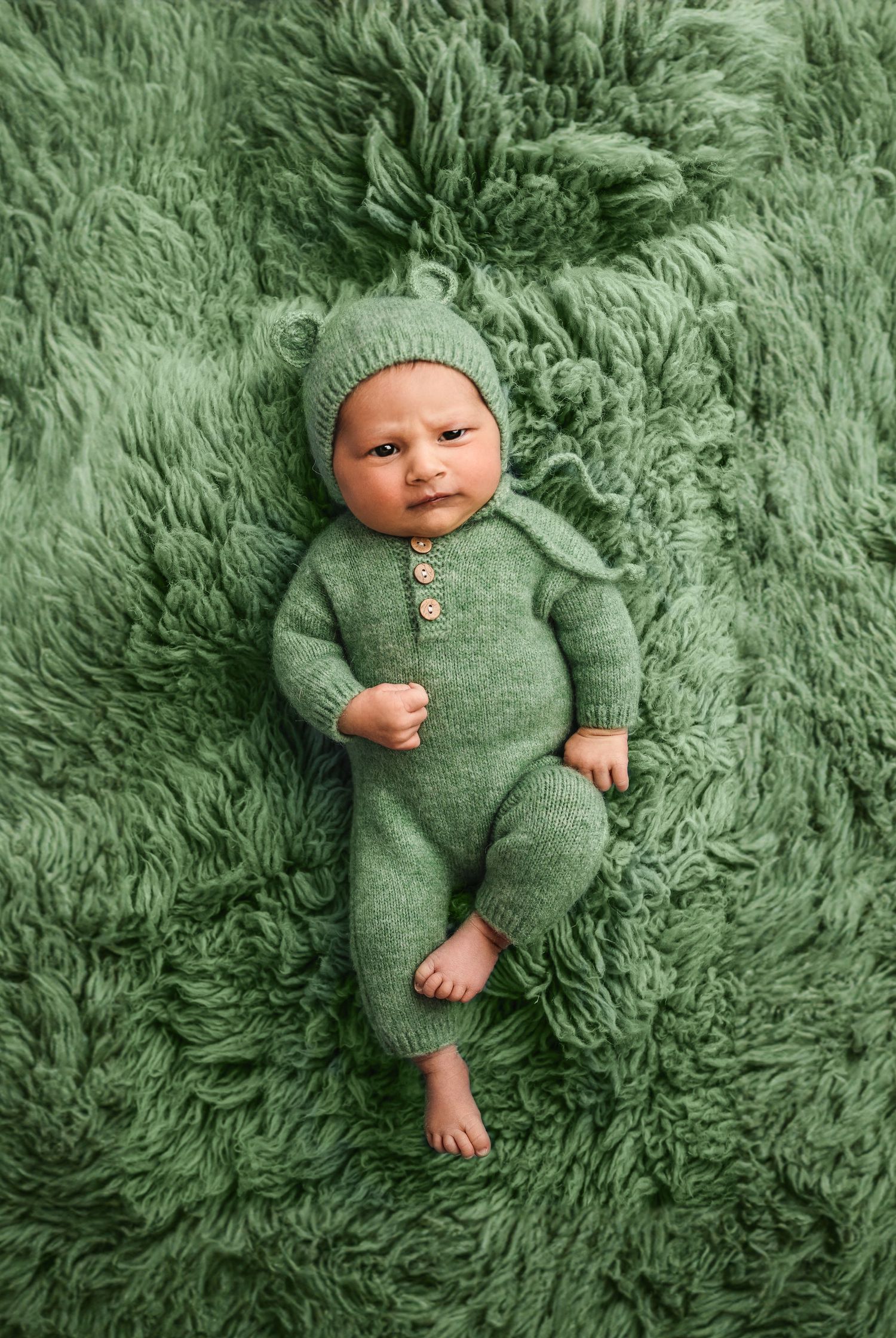 Charlottesville photographer, newborn, family, maternity, baby in green bear ear suit on green flokati