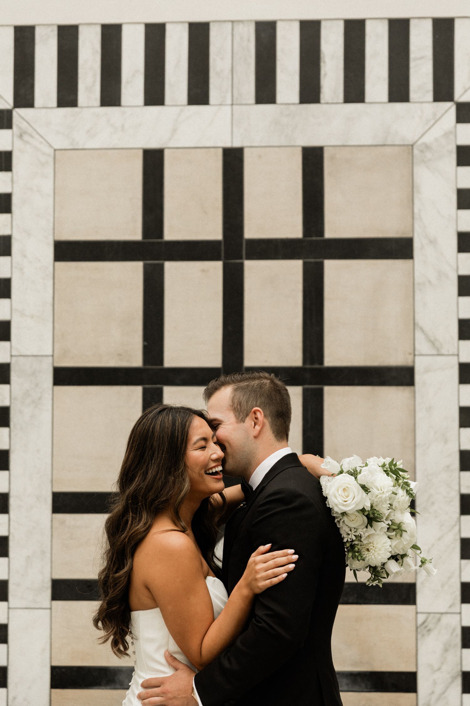 Asian Bride and Asian Groom walking away from the sunset, smiling at each other.