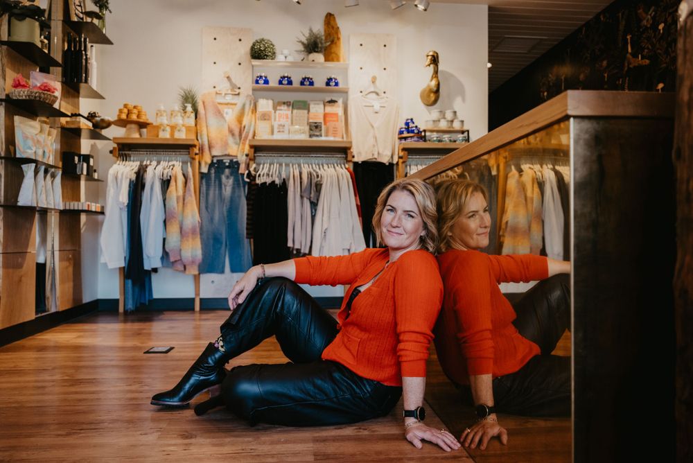 Interior view of boutique clothing store with retail display and merchandise.