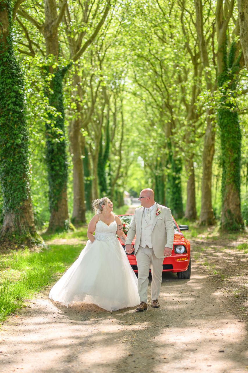 A romantic wedding couple poses in a series of elegant shots under stone archways at a historic European castle.