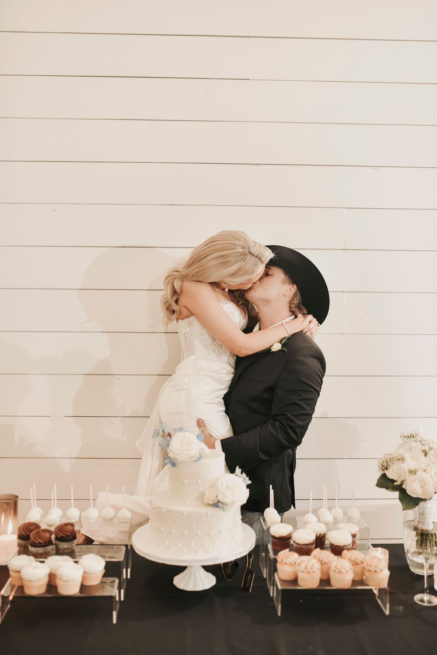 Newlyweds share cake cutting moment during reception