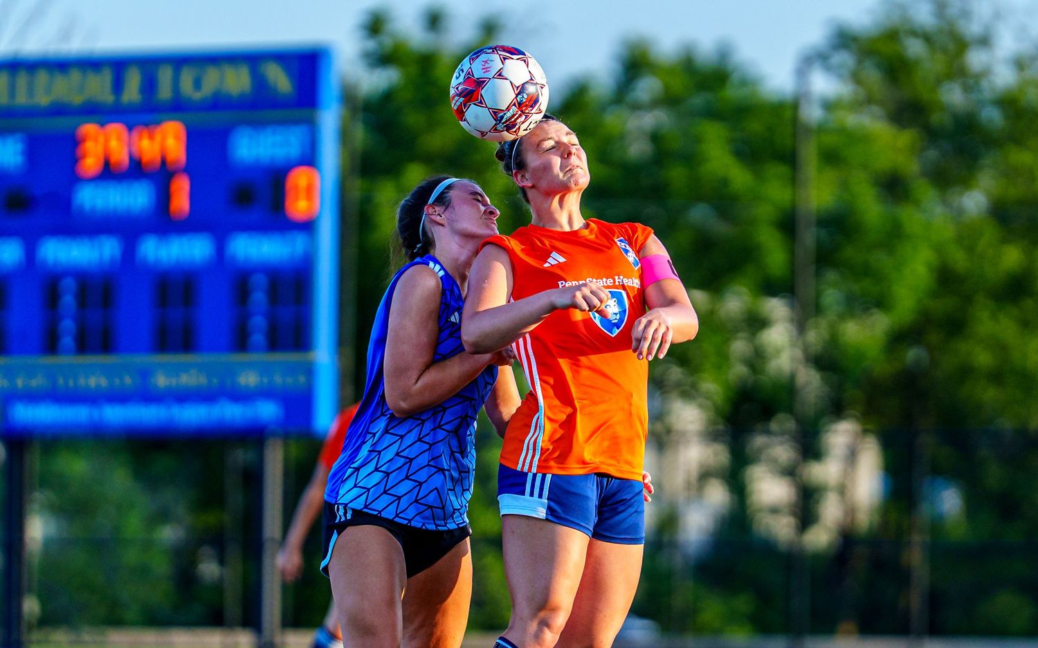 Hershey FC player goes up for a header in a WPSL women's soccer match at Middletown, by Deanna Fox, SportsFox Photography, Hershey PA