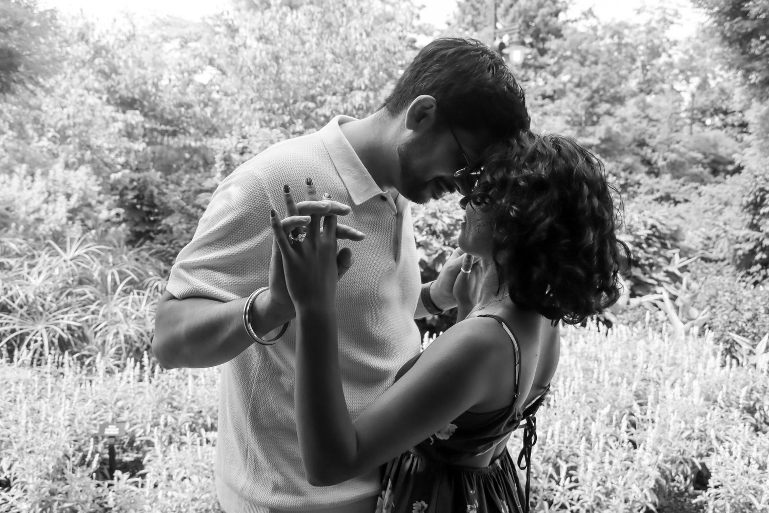 Surprise proposal at the Cincinnati Zoo featuring romantic engagement photography, lush greenery, and emotional candid moment