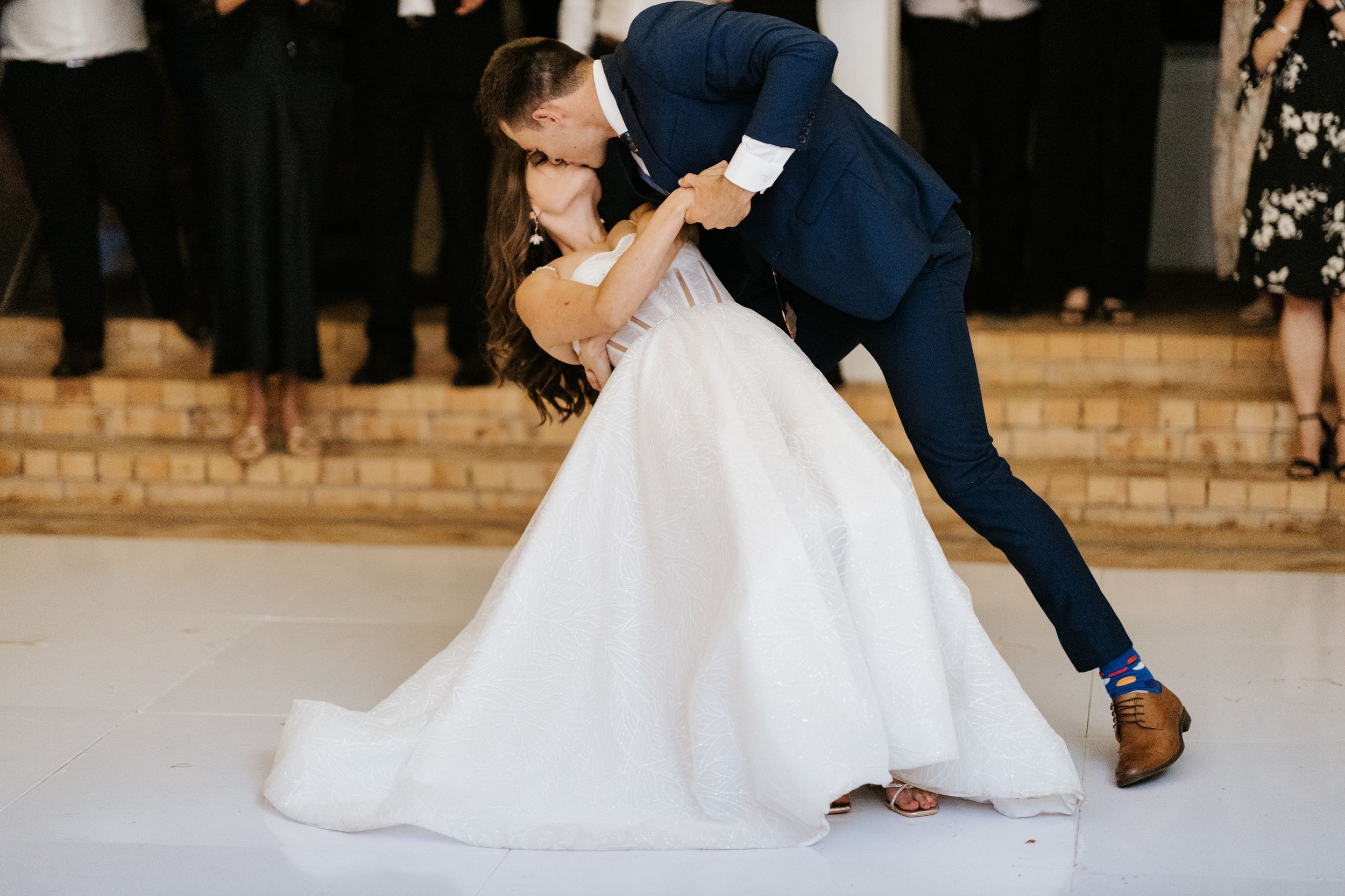 Dramatic dip during first dance at elegant wedding reception.