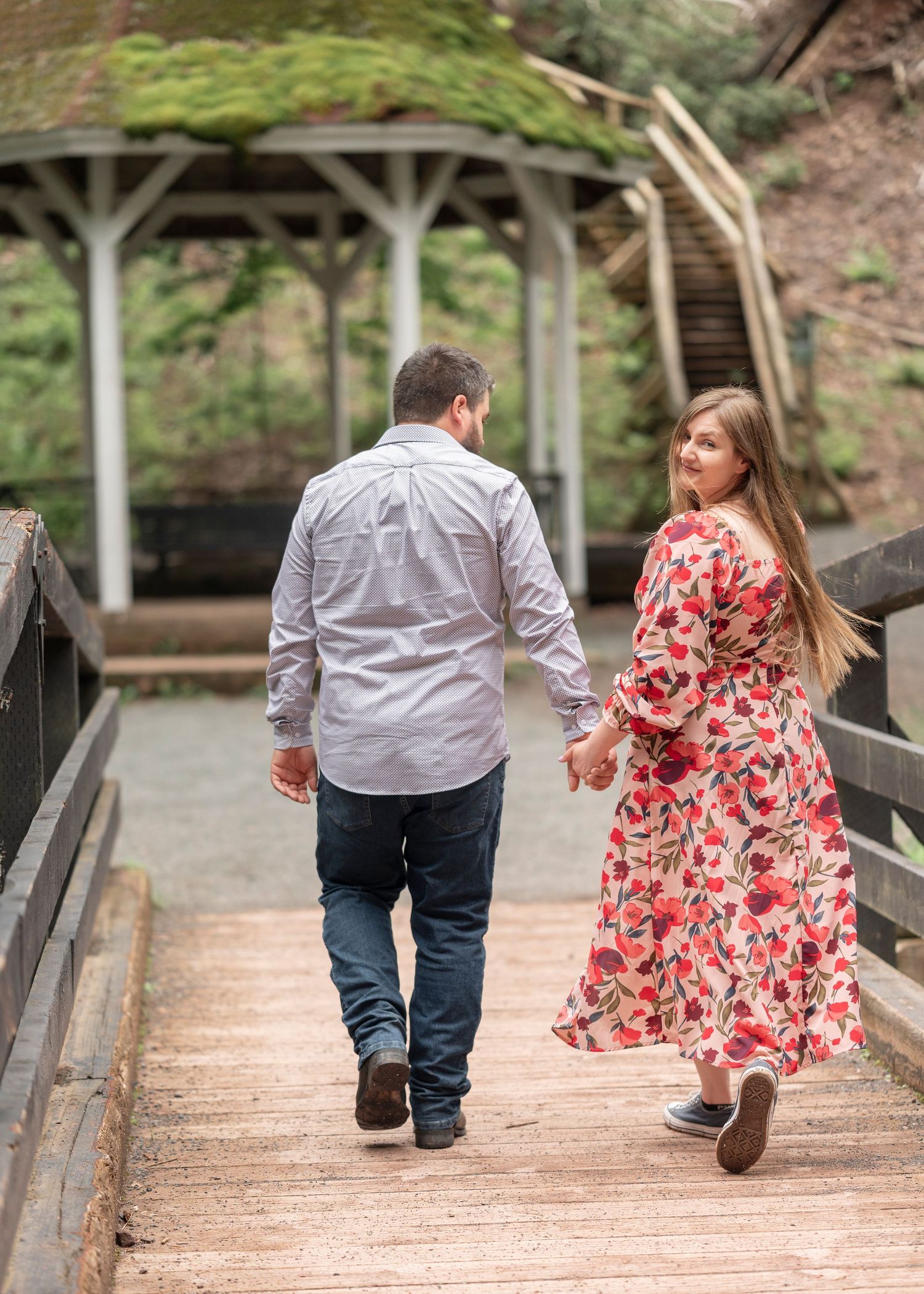 A couple walking through Victoria park in Truro for a whimsical forest stroll.
