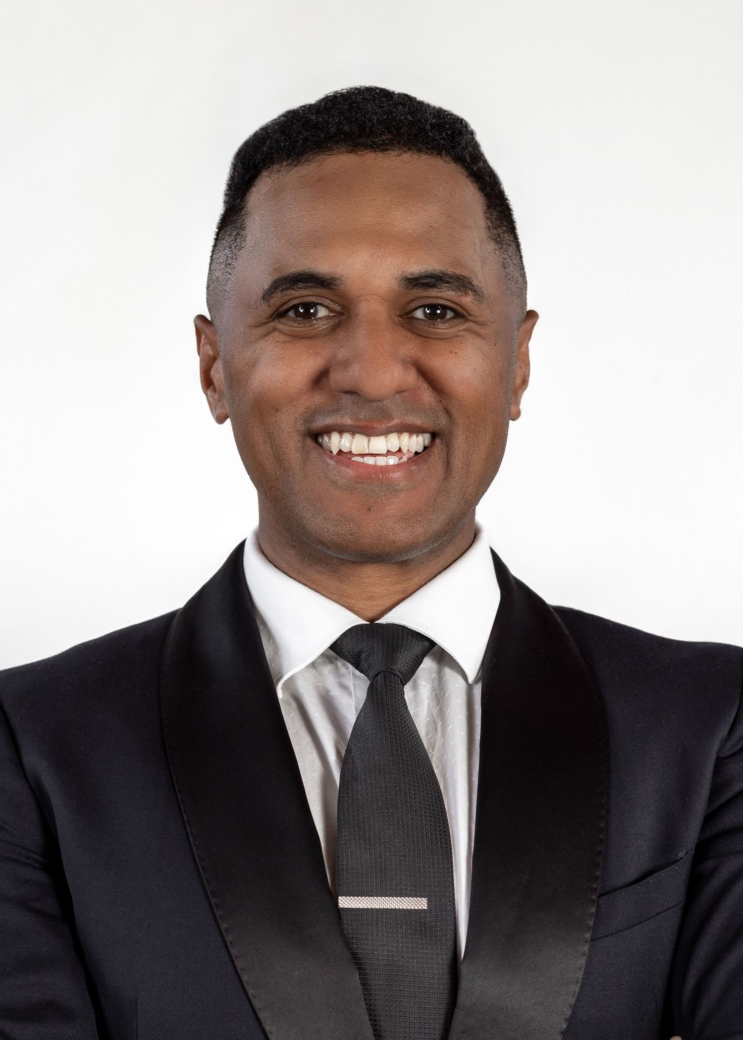 Professional portrait of Maori male in a business suit and tie. Headshot. Smiling for a headshot. Clean cut. Pearly whites.Teaorere Redmond.