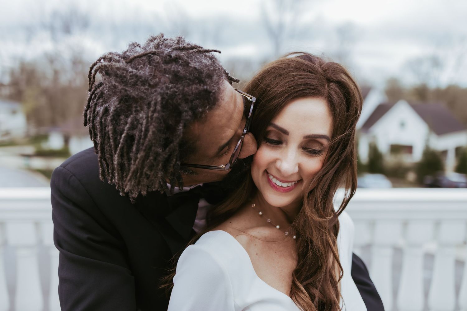 Bride and groom, wedding portrait kissing on a windy day at Holliday Farms in Zionsville, Indiana