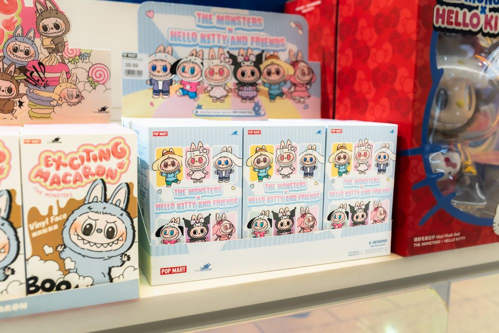 Tokidoki Hello Kitty and Friends blind box figures displayed on a retail shelf alongside other collectible toy sets.
