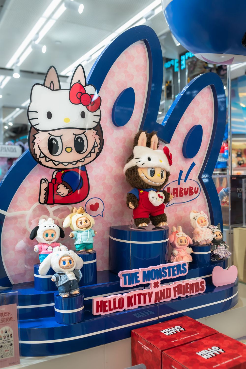 Hello Kitty and The Monsters collectible figurines displayed at a retail store exhibit.