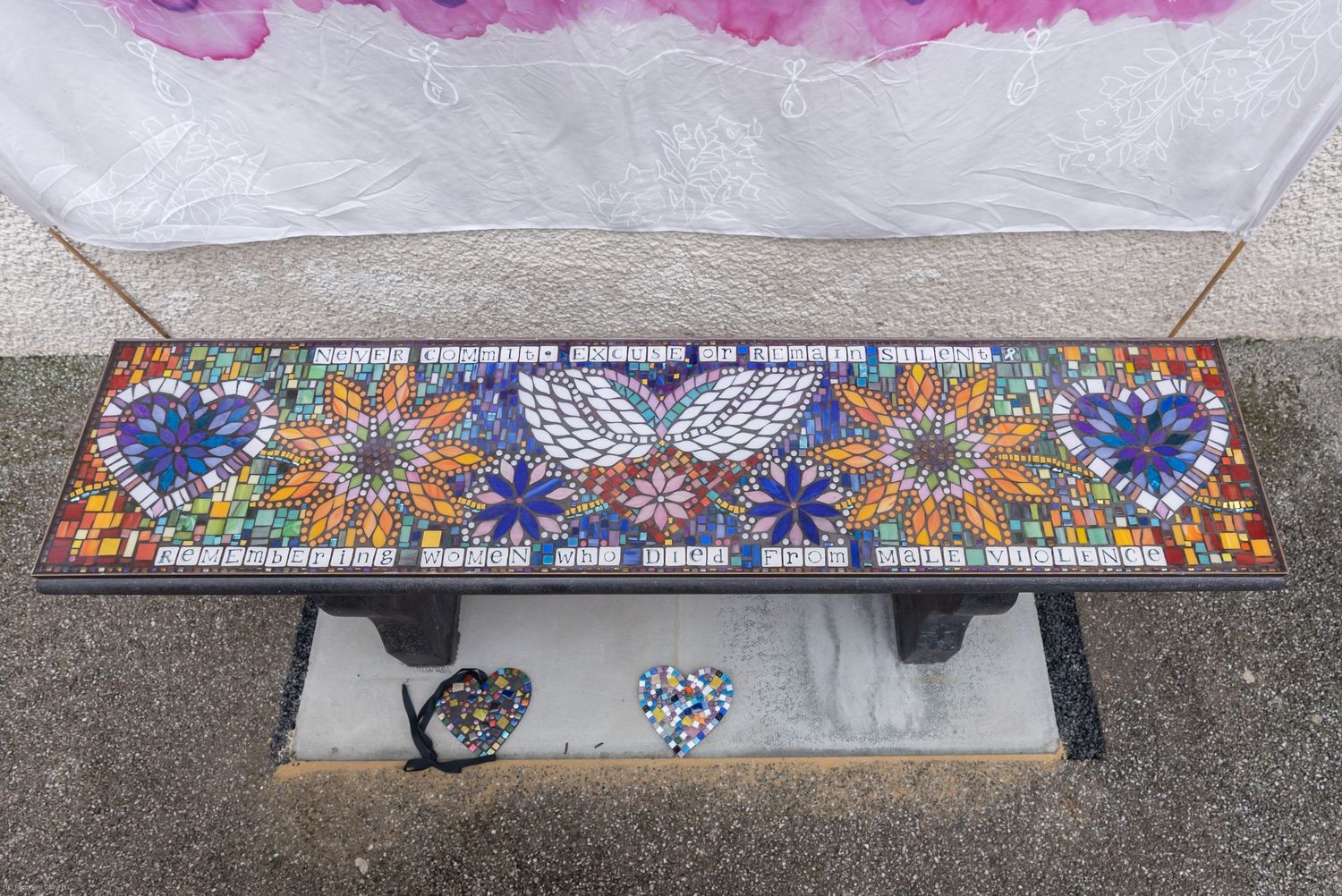 Several colorful mosaic tiled borders with floral and butterfly patterns decorate long narrow spaces.