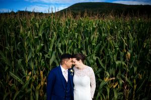 wedding couple embracing in a Vermont cornfield