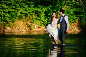 Wedding couple goes for a walk in the river in Northfield Vermont