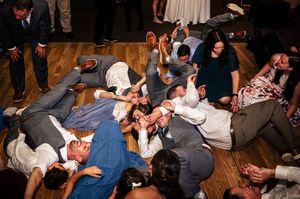 wedding guests pile on top of one another for a dance finale at a wedding reception at Sugarbush in Vermont