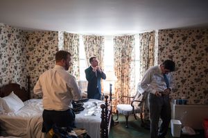 Groomsmen get ready before a wedding together.