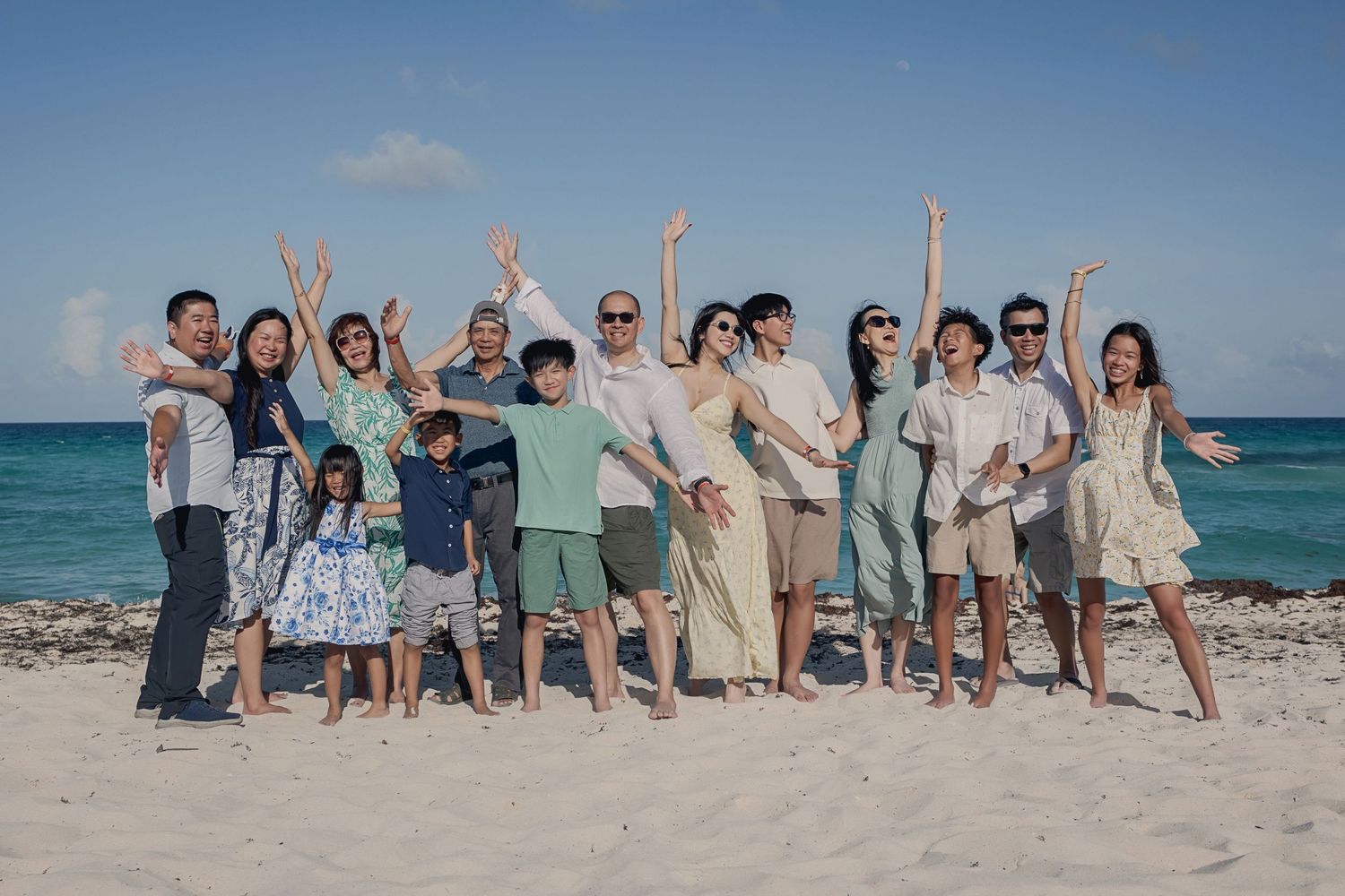 Large family enjoying a beach photo session in Cancún, Mexico.