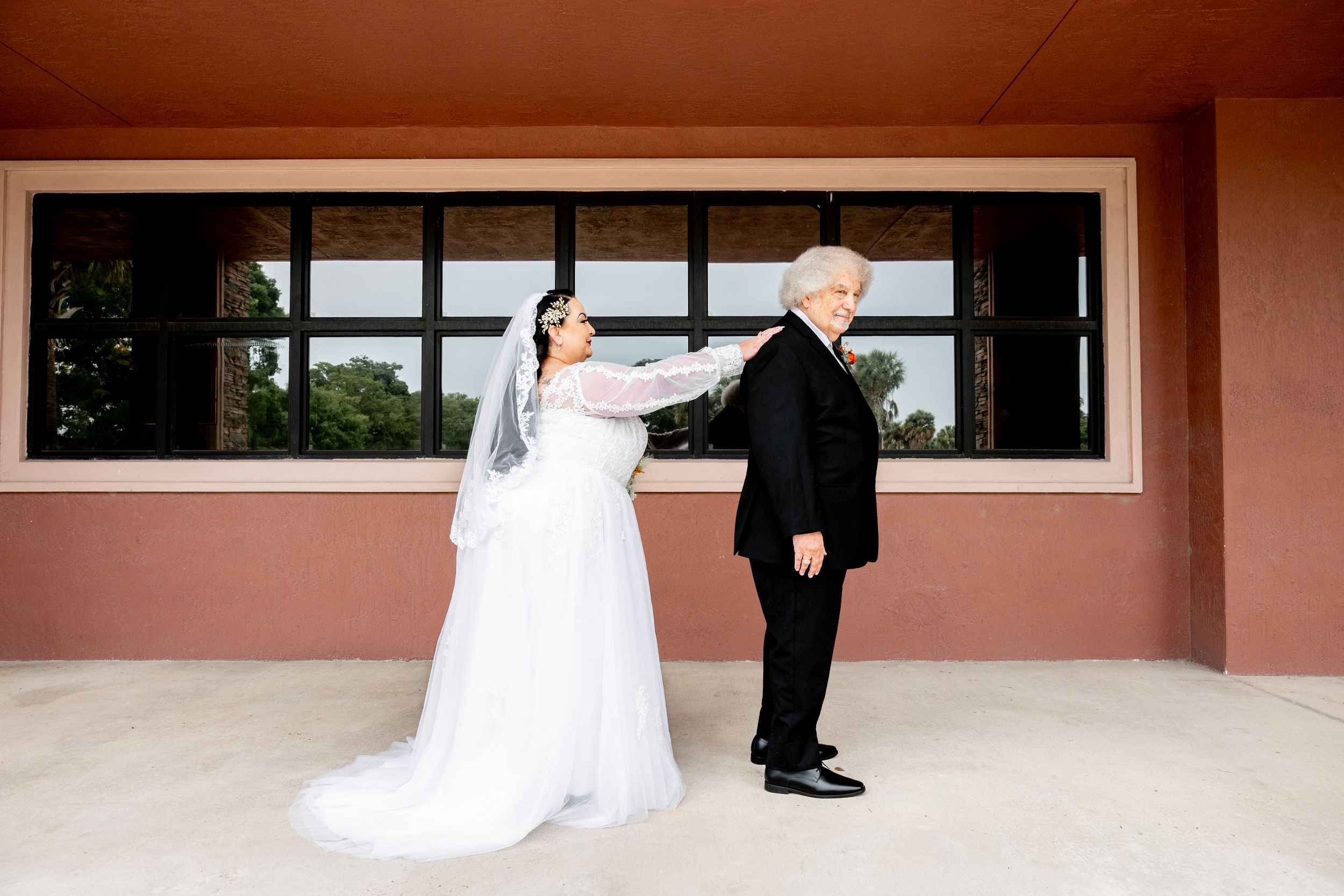 Wedding photography session at a modern venue with terracotta colored walls.