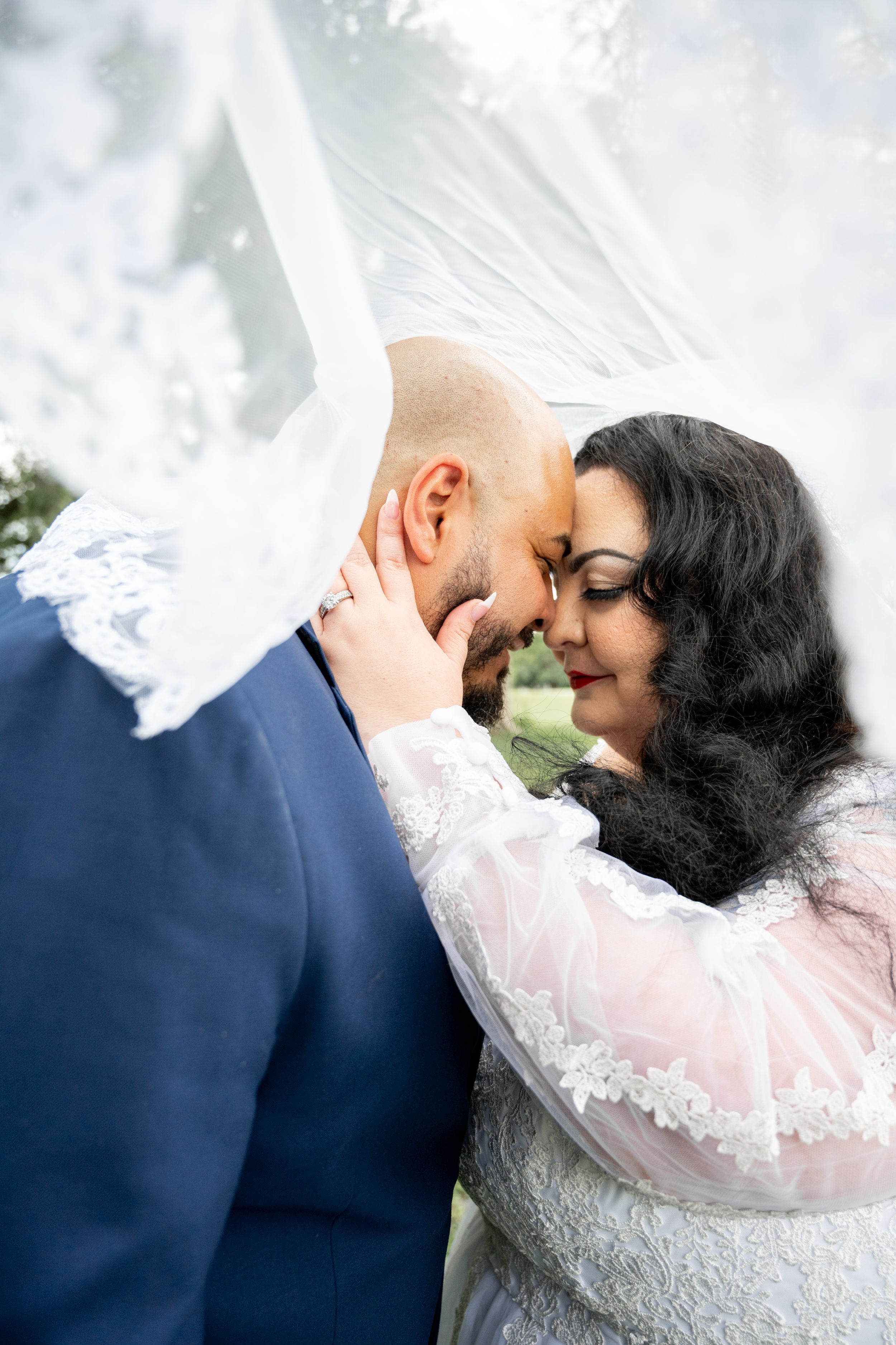 Romantic wedding moment captured against a soft white background.