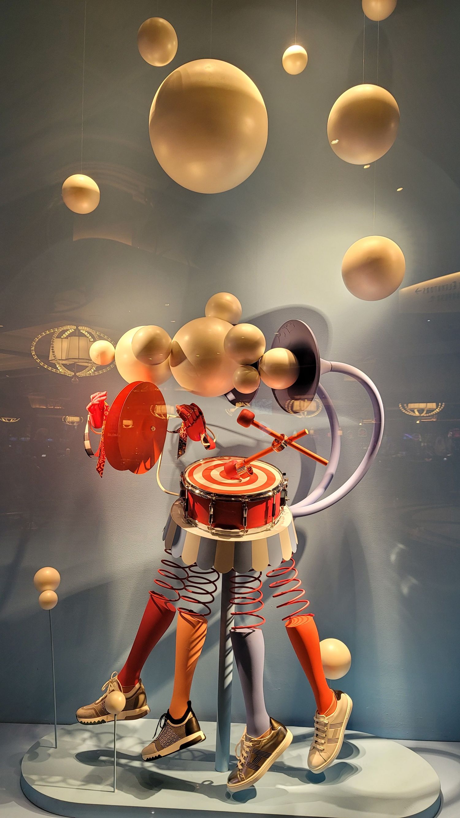 Whimsical space-themed art sculpture with planets on display in a Las Vegas hotel, taken with a smartphone