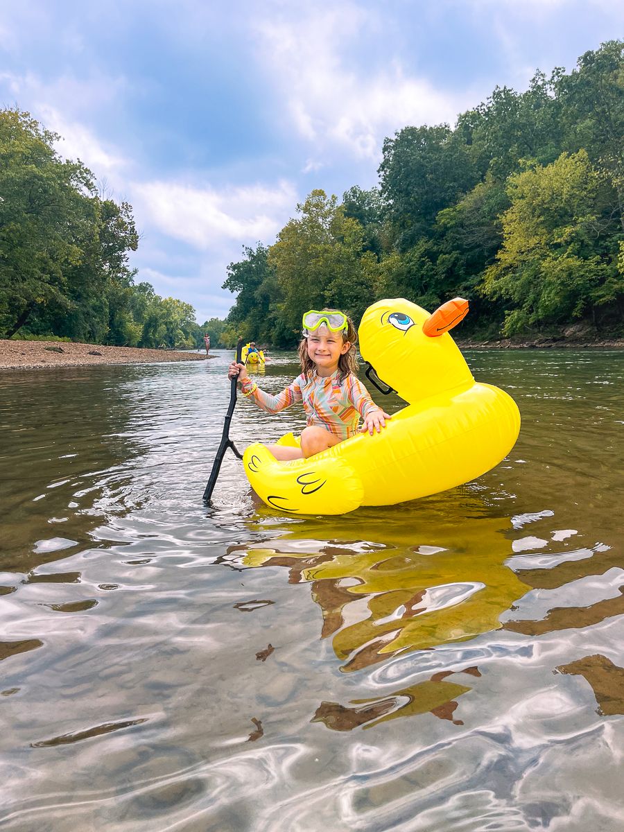 A young girl on a duck float in a Arkansas river, by Delta Blossoms Photography