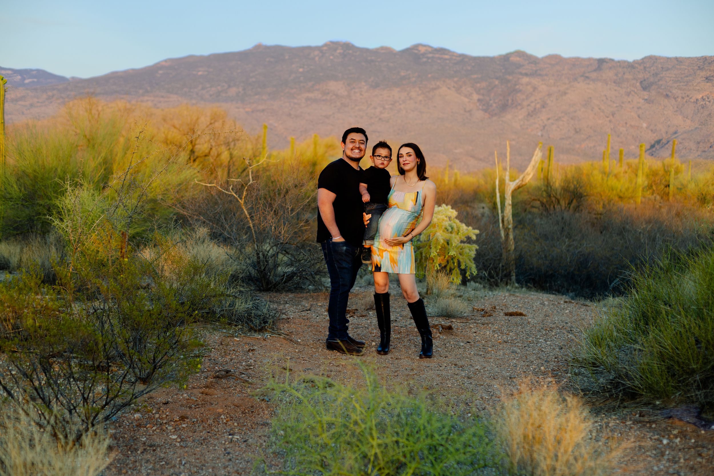 Desert landscape photo session at sunset with mountains in background.