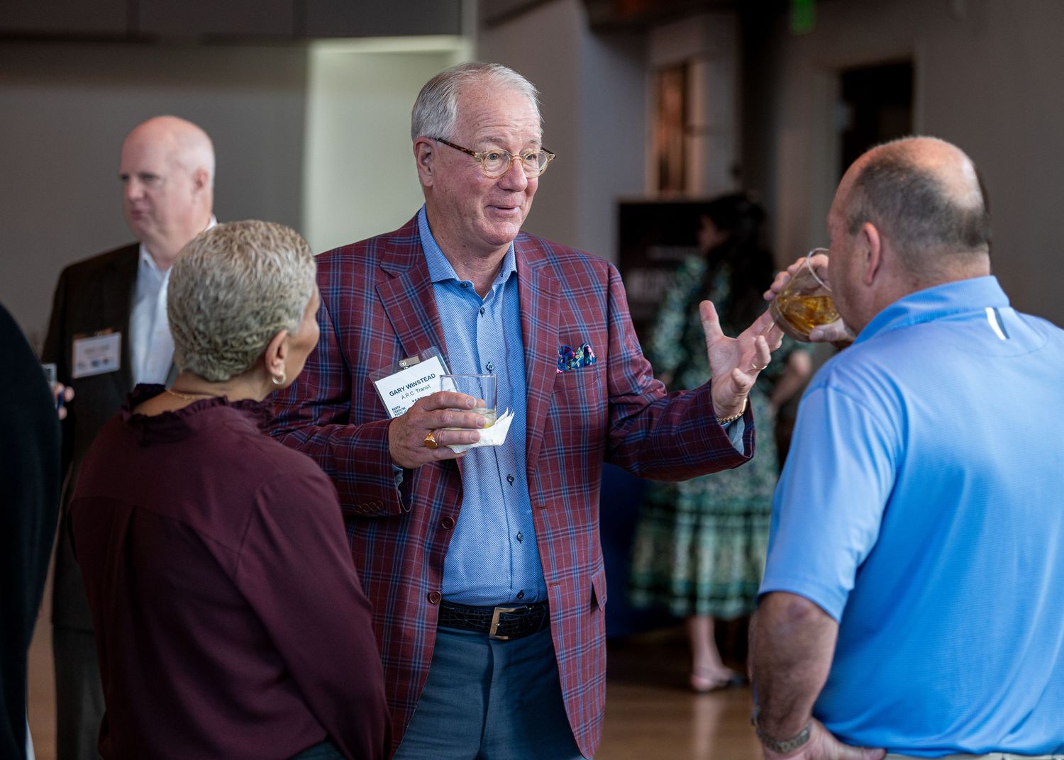 Lively conversation among attendees at indoor business networking event.