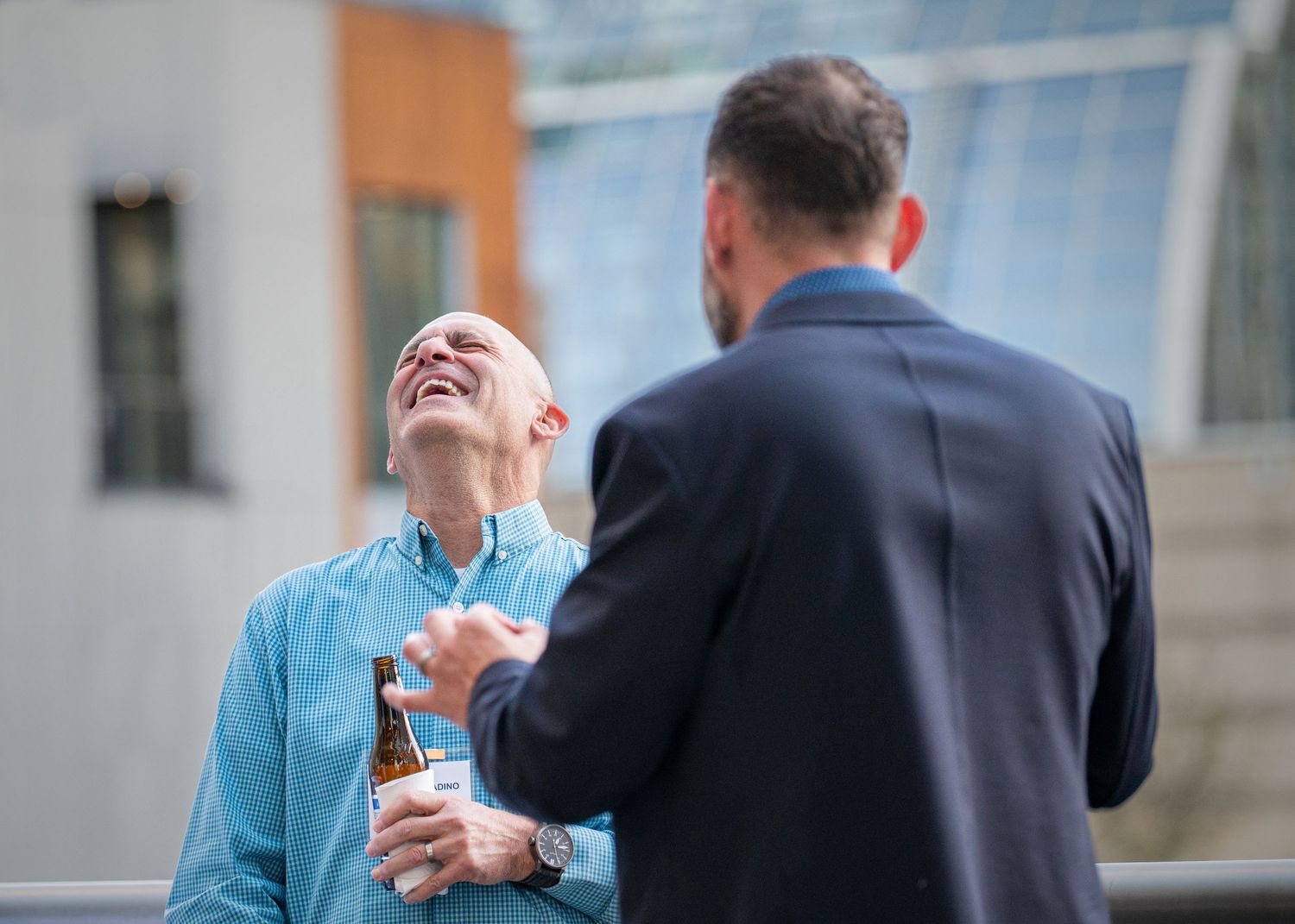 Business professionals networking and conversing at a professional reception event.