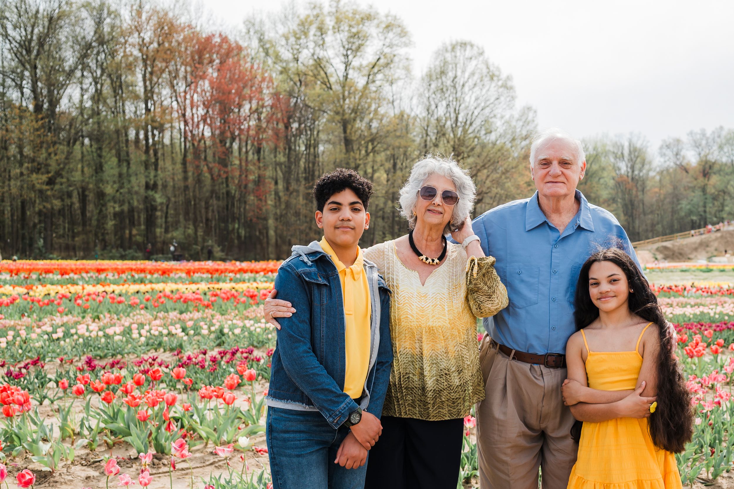 Group enjoying a spring day together at a colorful tulip field during peak bloom season.