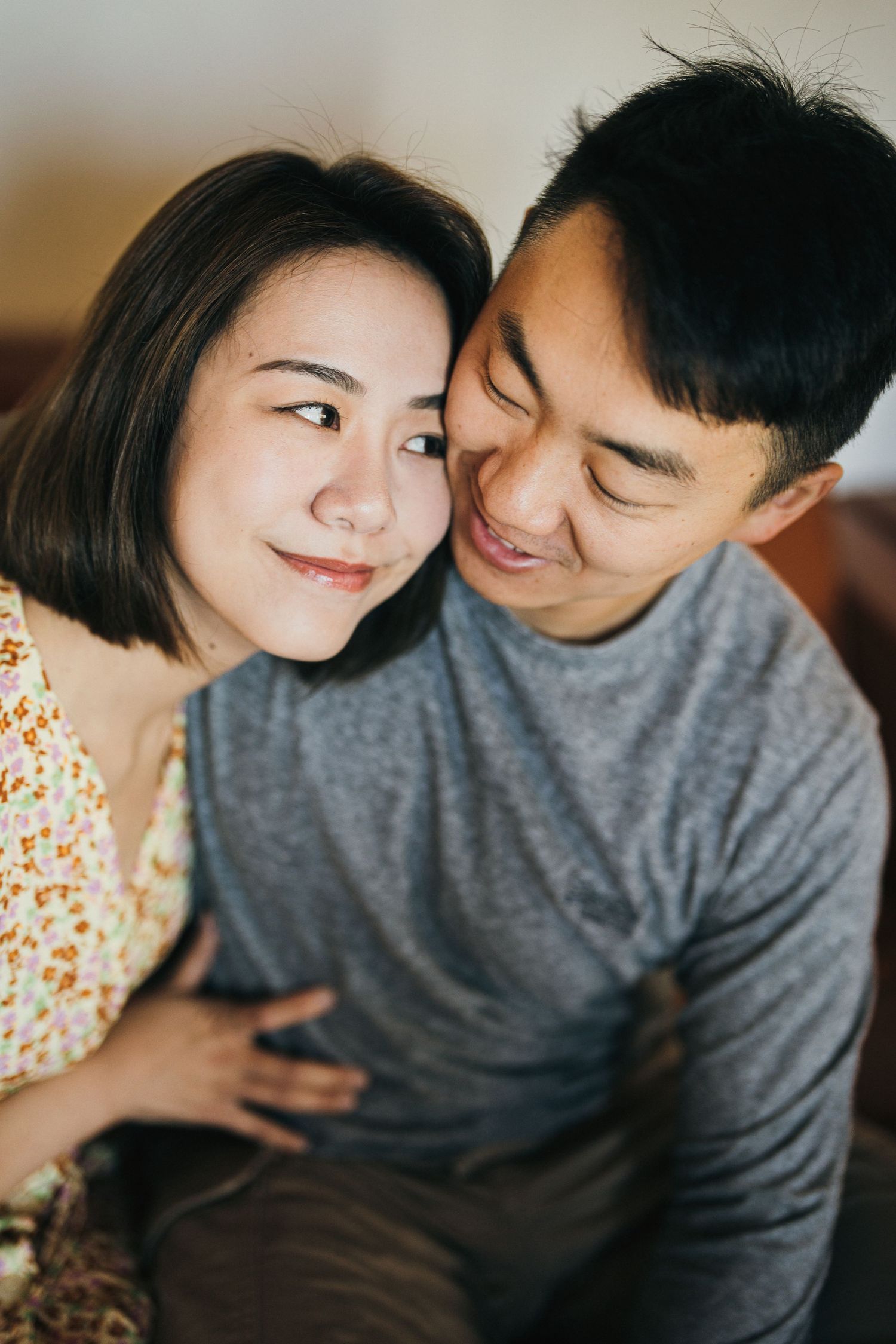 A romantic couple shares an intimate moment while wearing casual clothing.