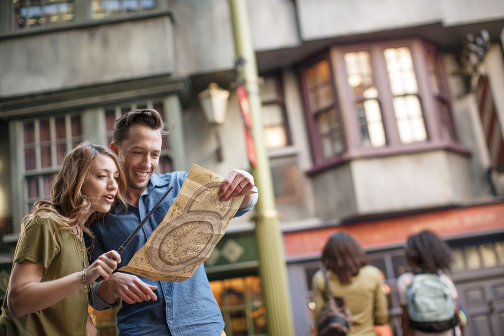 Tourists consulting a map while sightseeing in a charming European city street with historic buildings.