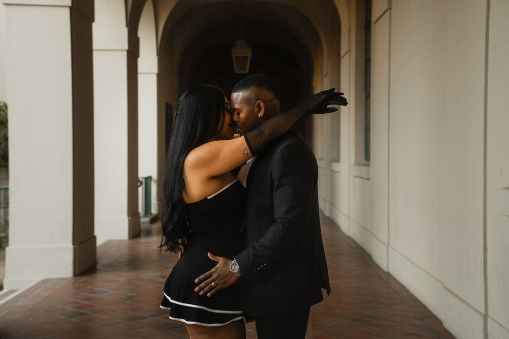 Elegant couple posing at Pasadena City Hall entrance