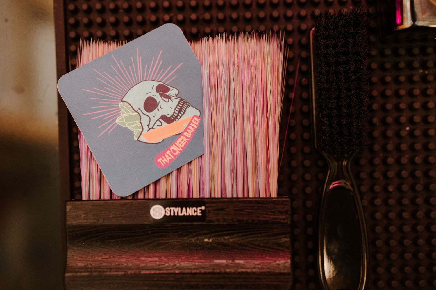 A close-up view of recording equipment with a cartoon sticker in a studio setting.