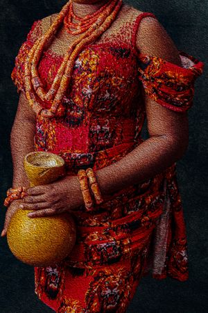 Photography Oil painting Close-up of an Igbo brides red traditional dress with beaded necklaces and bracelets holding a golden calabash.