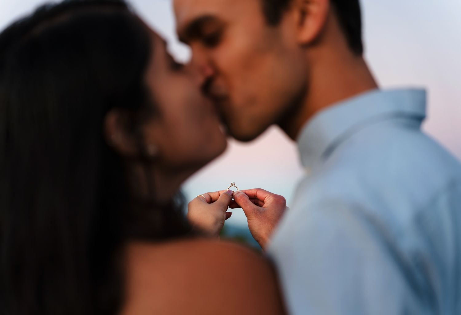 Couple showing their engagement ring during sunset at Mount Victoria Lookout