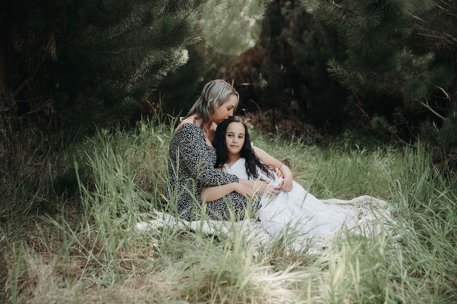 A serene outdoor portrait in tall grass with gentle natural lighting.