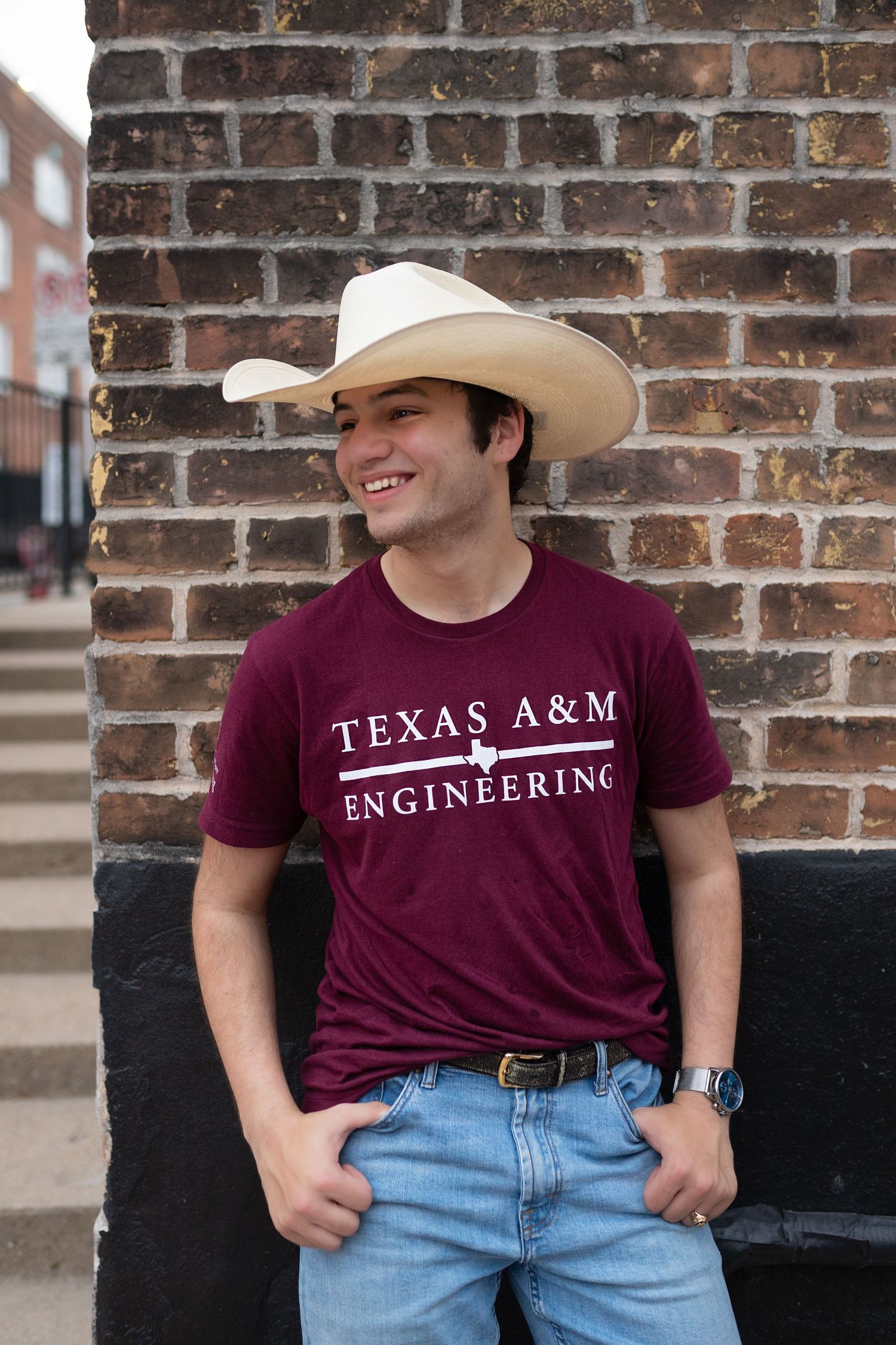 Senior session in Downtown Houston. Senior wearing A&M t-shirt and cowboy hat for relaxed milestone session.