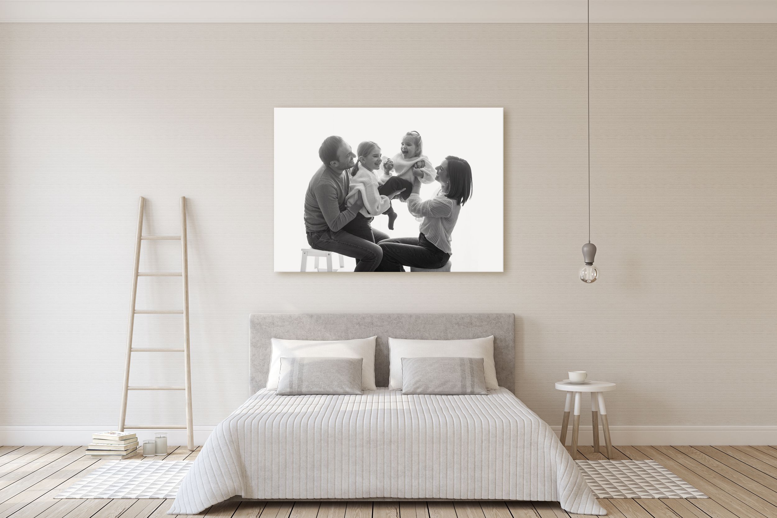 Modern minimalist bedroom with white bedding, wooden ladder, and large black and white photograph displayed above the bed.