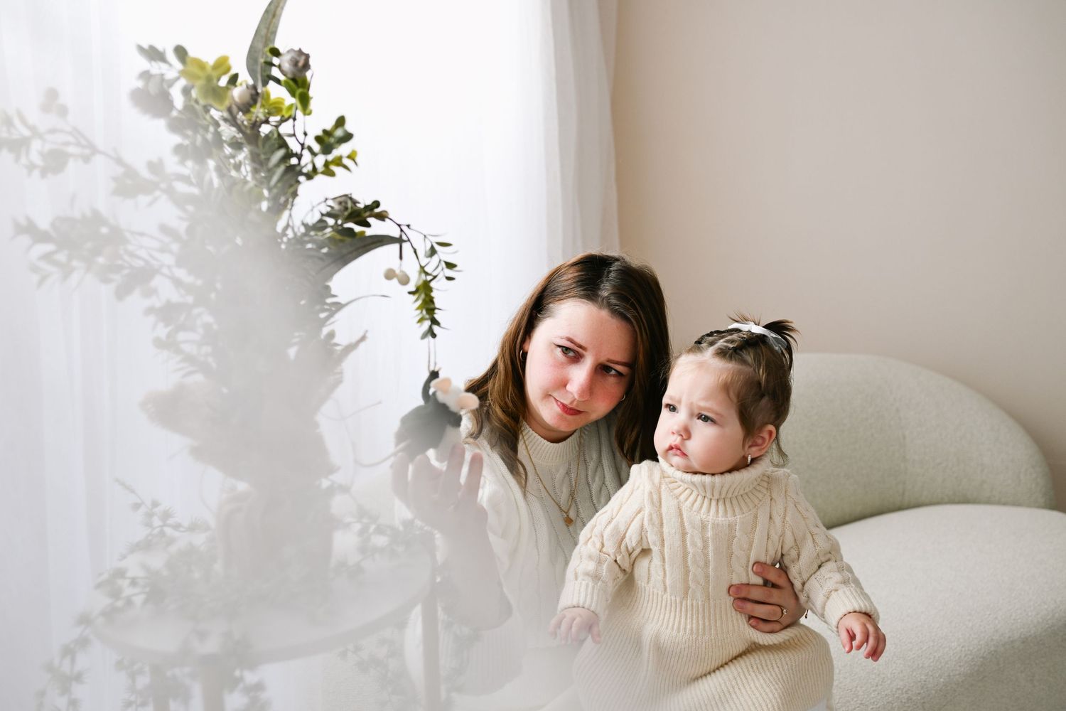 Lifestyle photography series capturing tender family moments in a bright white room.