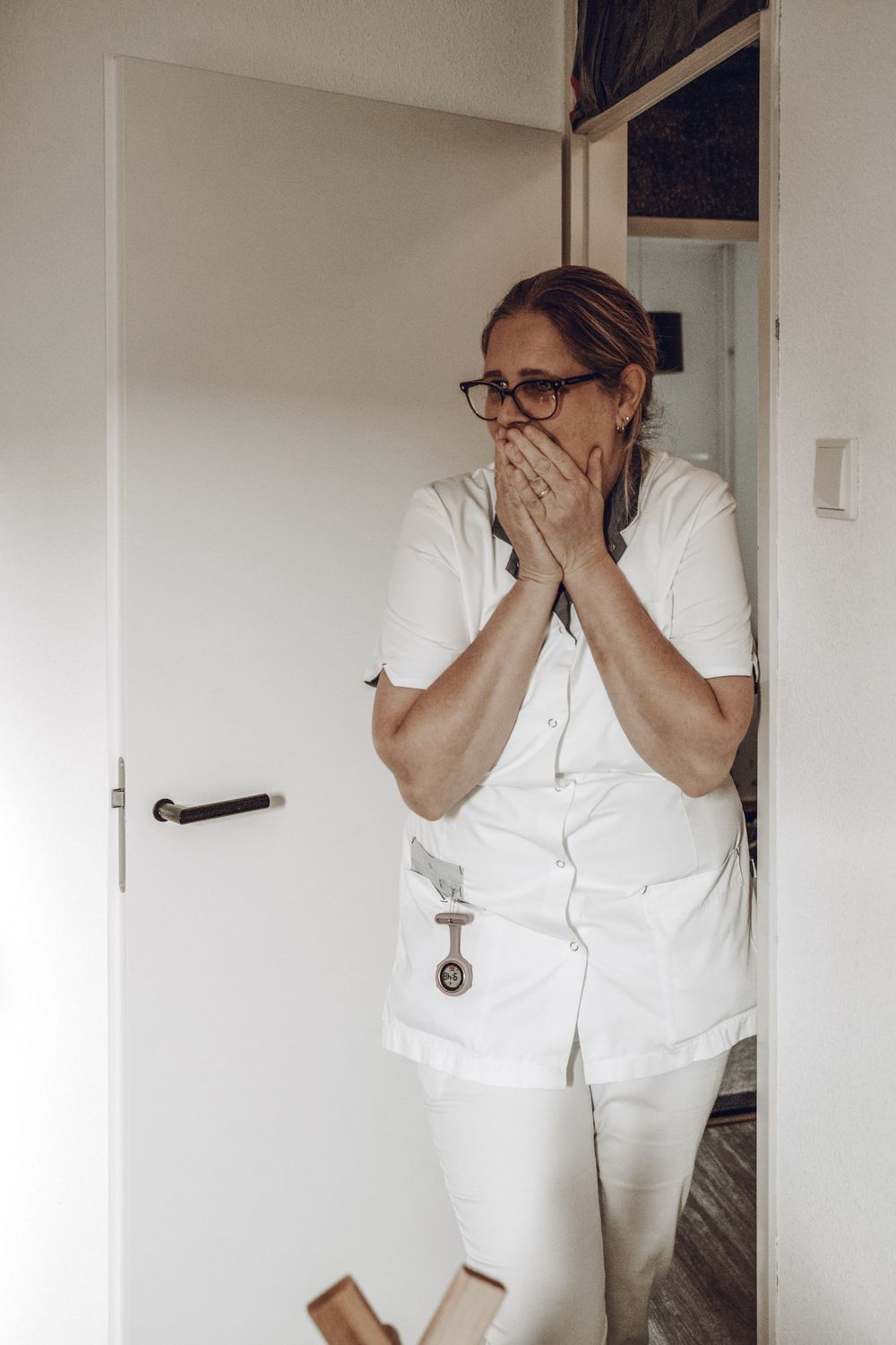 Series of photos showing someone in white clothing covering their face with their hands in different poses.
