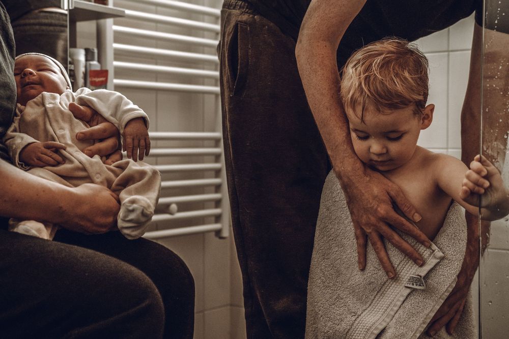 A series of black and white photos showing someone getting a professional straight razor shave at a barbershop.